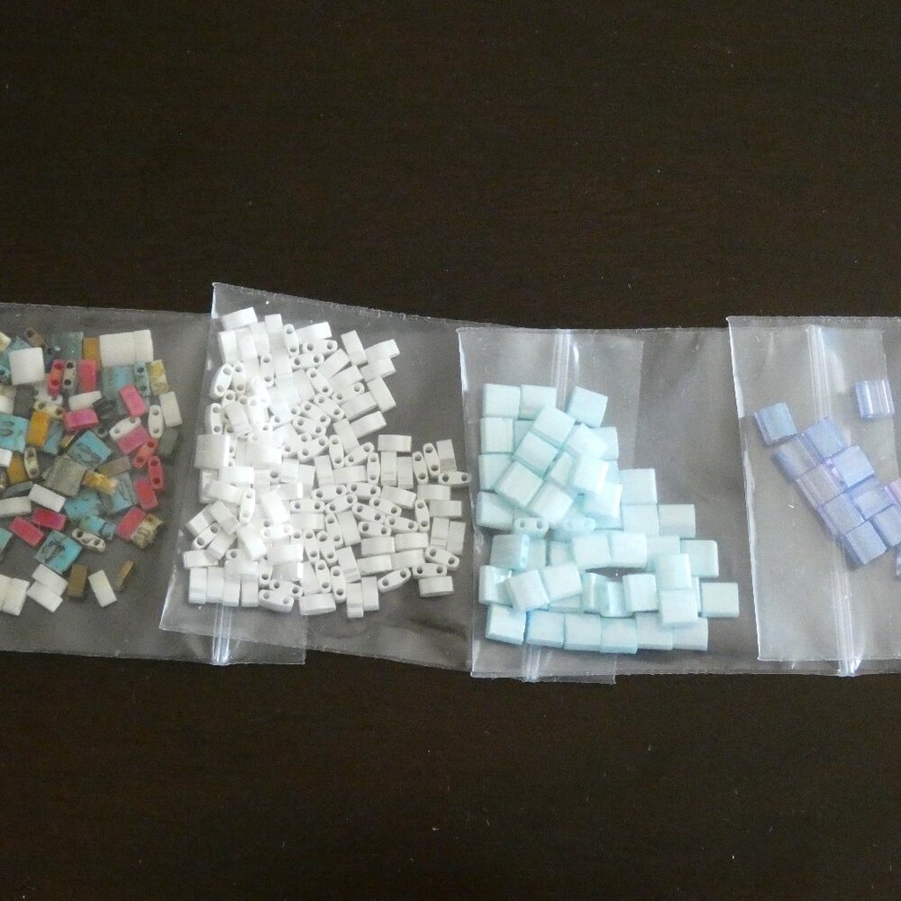 4 packages of Tila beads +  SEVERAL  bead bags and findings